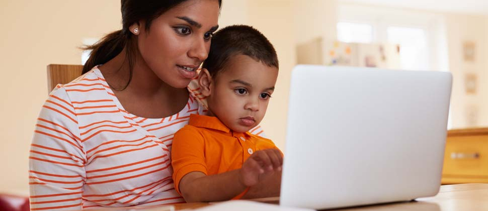 Woman and child on laptop