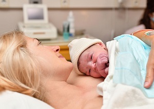 Woman holding baby after birth