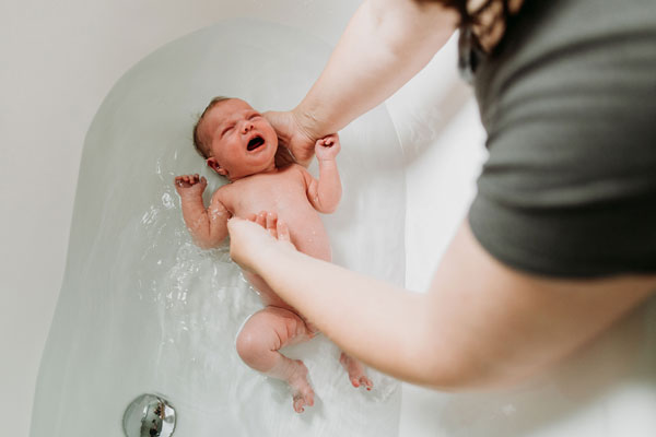Bathing a crying newborn