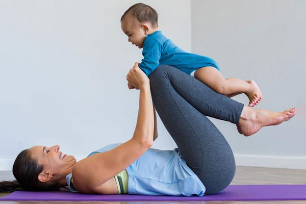 Mother and baby doing yoga