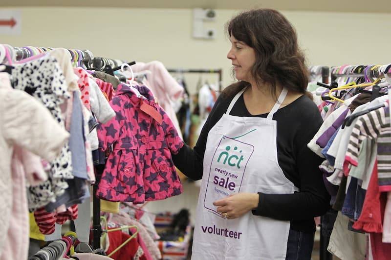 Volunteer working at a Nearly New Sale