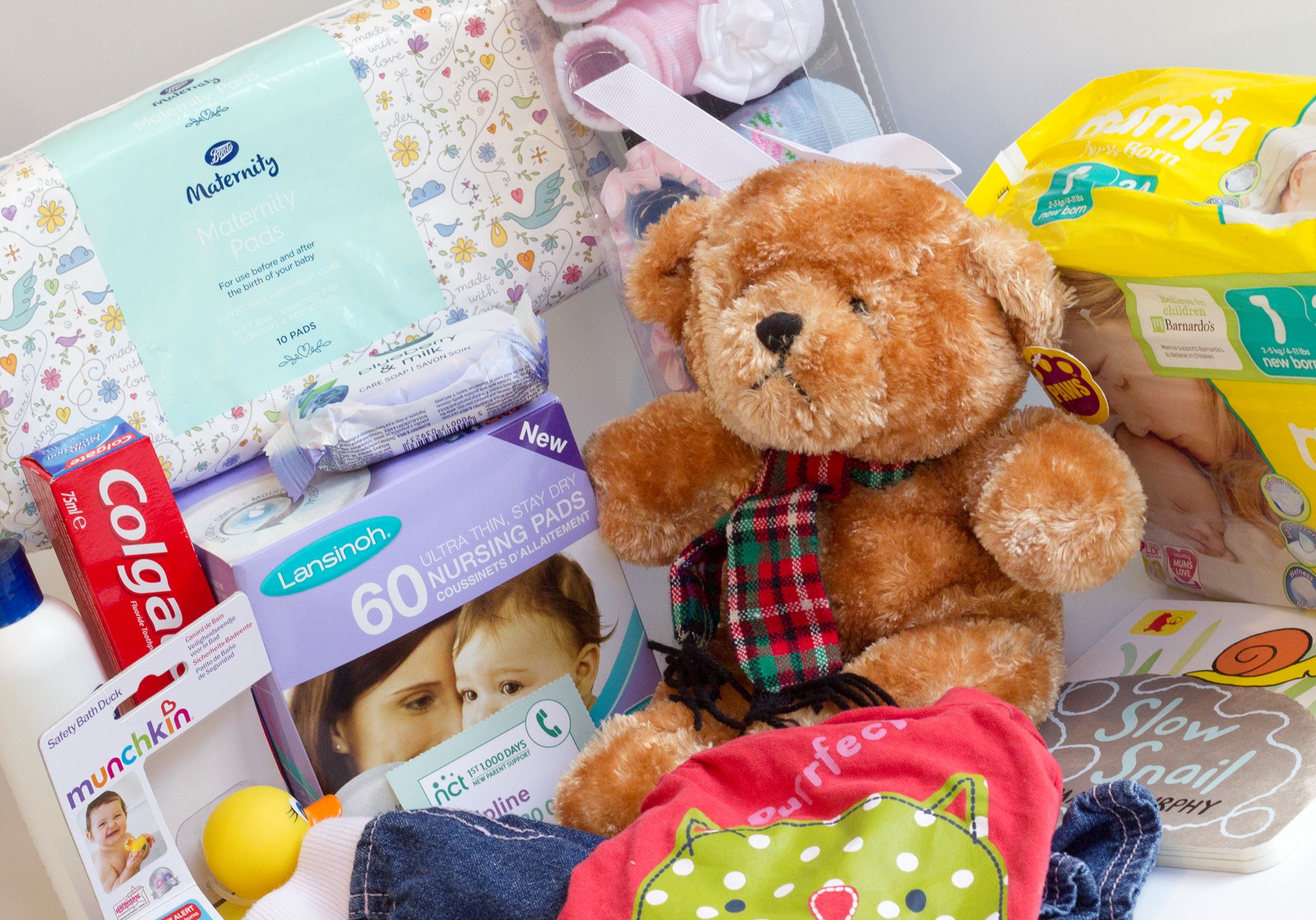 contents of baby bundle, bear, nappies, nursing pads