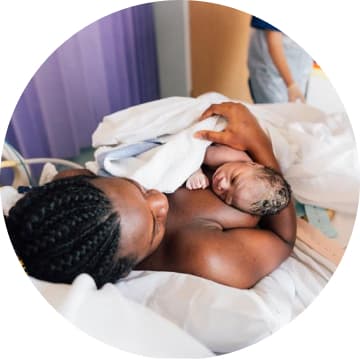 mum holding newborn baby in hospital