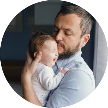 Father holding crycing newborn