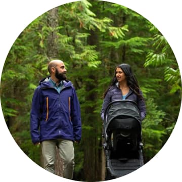 Parents walking with their baby in pram