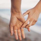 Couple holding hands on beach