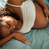Pregnant woman lying down on her side