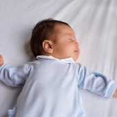 Baby asleep in a cot
