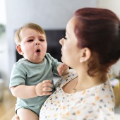 Parent holding a coughing baby