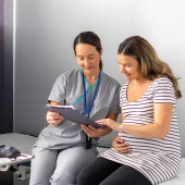 Pregnant parent looking at notes