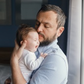 Parent holding a crying baby