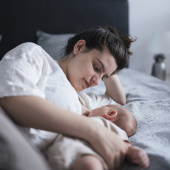 Mother or birthing person in bed with baby