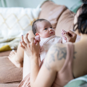 Parent looking at baby on a sofa