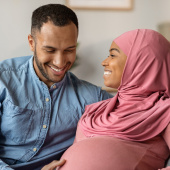 Couple with hands on baby
