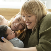 Parents with baby on bed