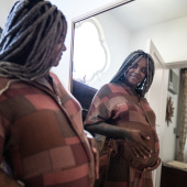 Pregnant woman or birthing person looking in a mirror