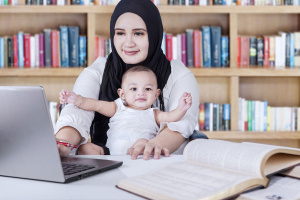 woman with baby and laptop