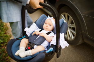 dad carrying baby in car seat