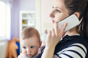 Mother with baby on phone