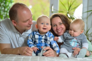 A family looking happy with twin babies