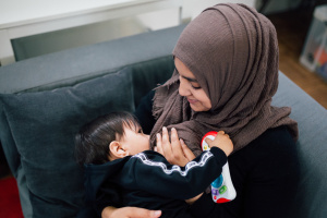 Muslim woman breastfeeding her baby