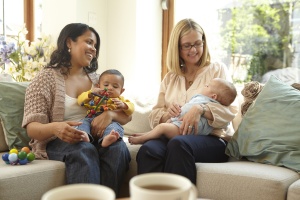 Two-parents-laughing-holding-their-babies