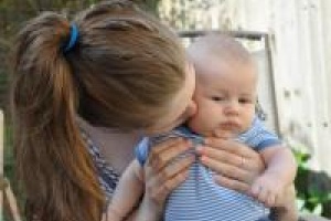 Mum kissing baby 