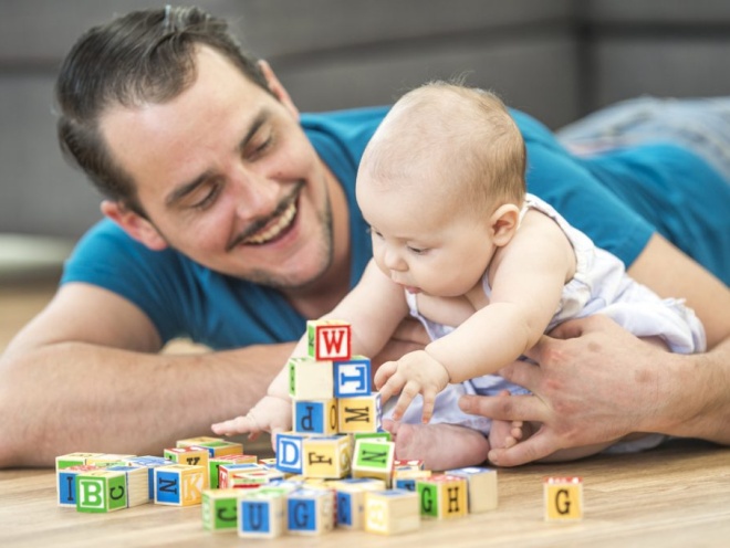 Dad playing with baby