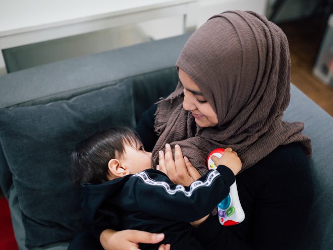 Muslim woman breastfeeding her baby
