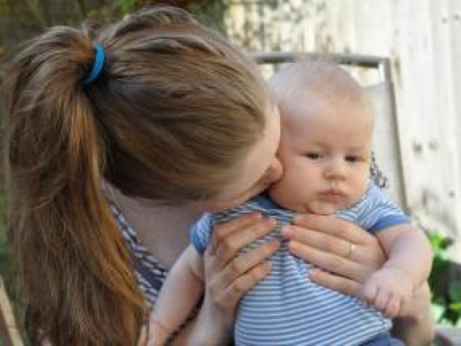 Mum kissing baby