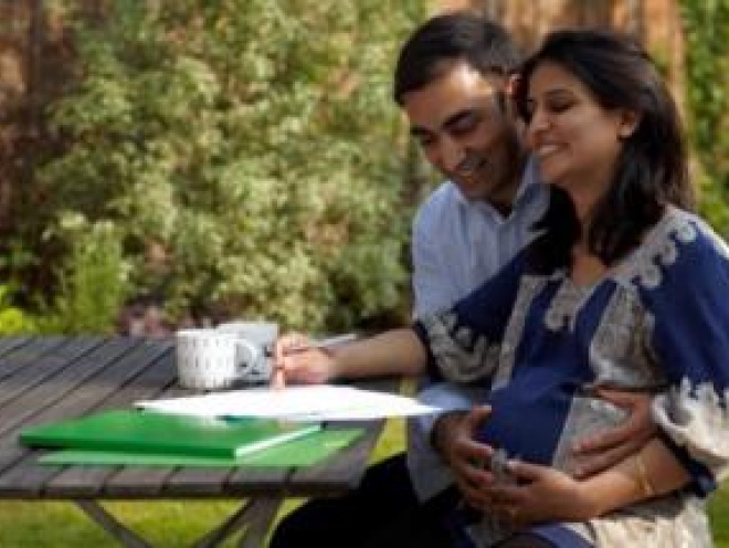 Couple hugging discussing birth plan