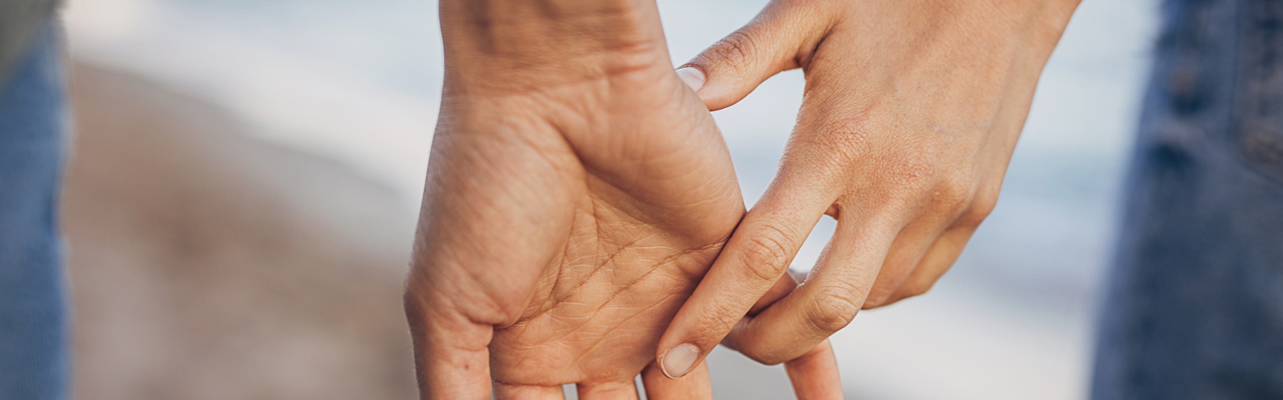 Couple holding hands on beach