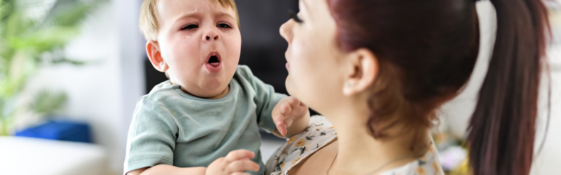 Parent holding a coughing baby