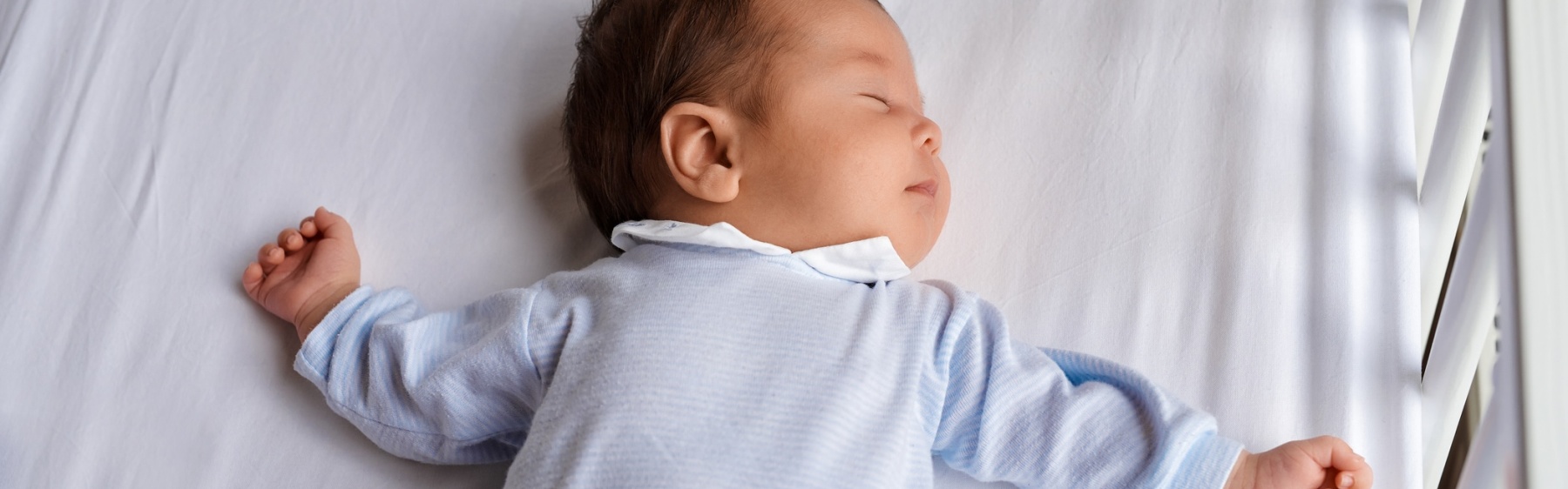 Baby asleep in a cot