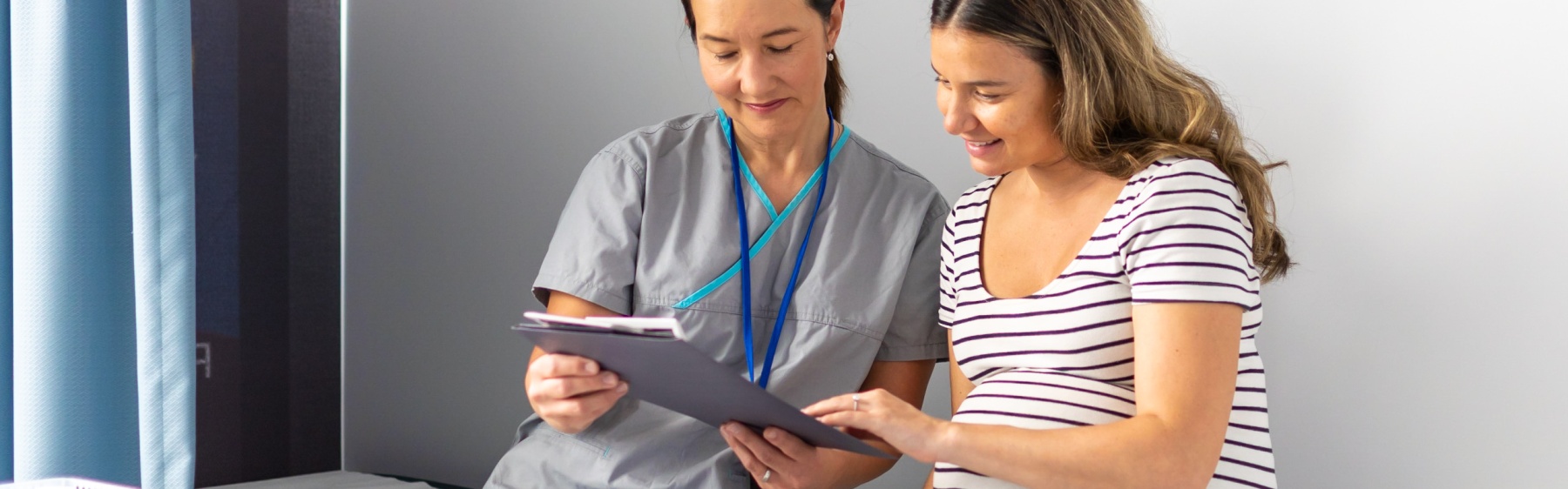 Pregnant parent looking at notes