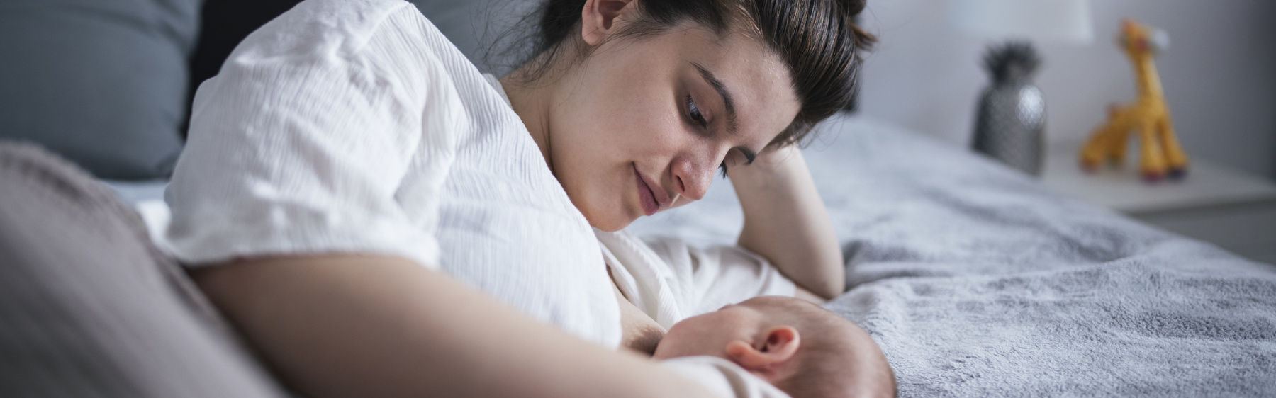 Mother or birthing person in bed with baby