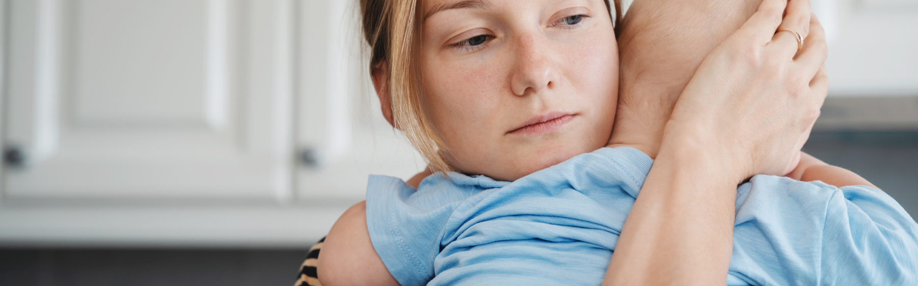 Mother holding sick baby
