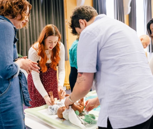 Antenatal class learning to change a nappy