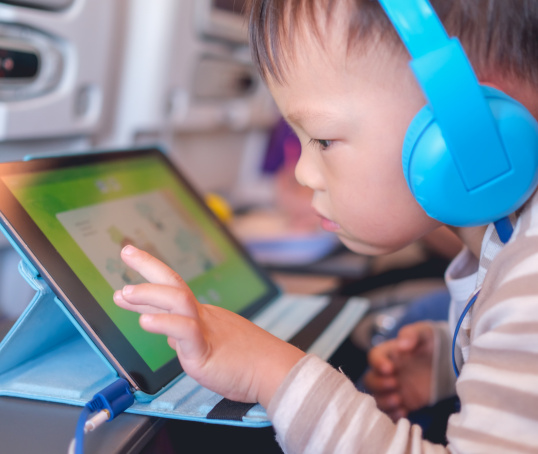 Child on iPad wearing headphones