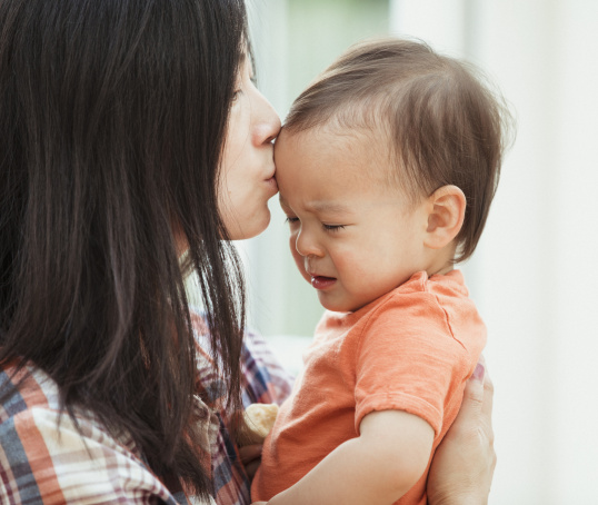 Parent kissing baby