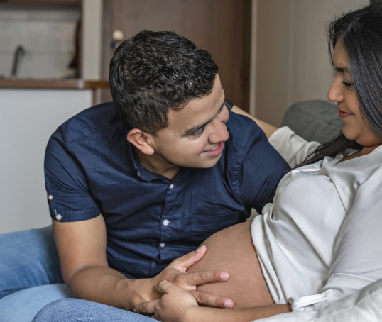 Couple sitting on the sofa with pregnant woman.jpg