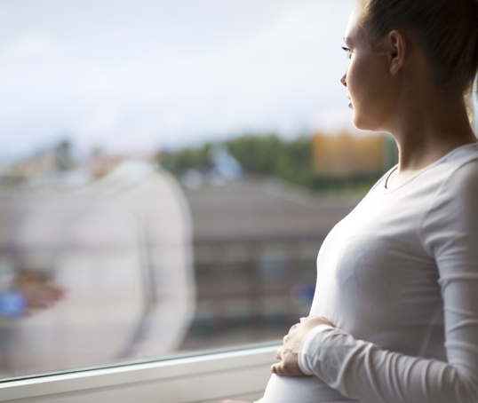 Pregnant woman or person looking out of the window