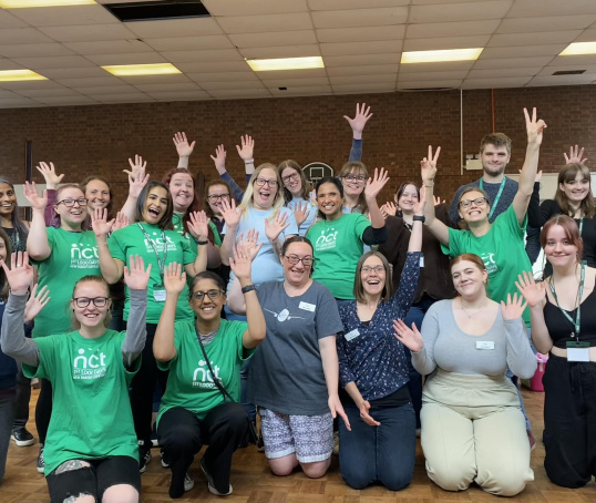 Nearly New Sales volunteer group smiling and waving