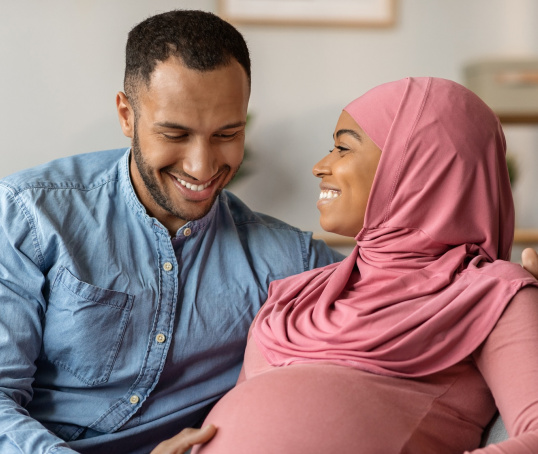 Couple with hands on baby