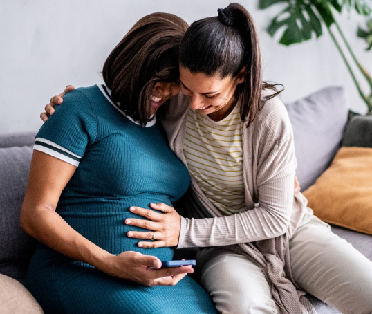 Pregnant couple feeling tummy