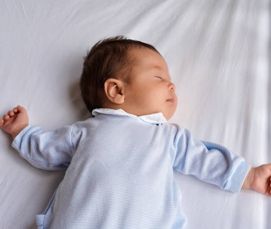Baby asleep in a cot
