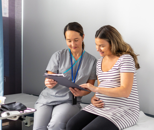 Pregnant parent looking at notes