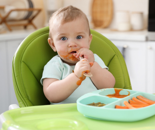 Baby eating solid food