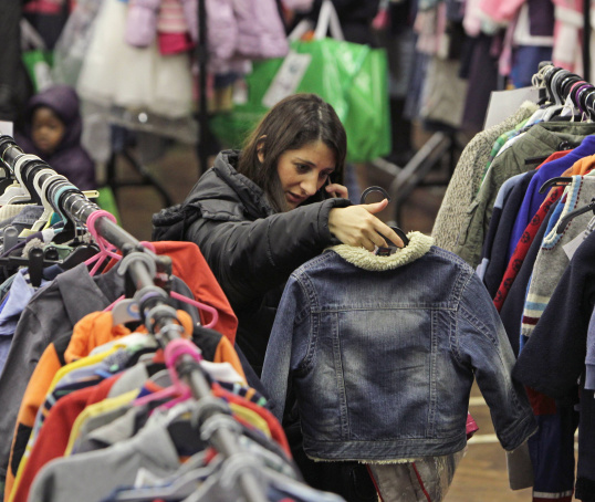 Woman shopping amongst clothing rails