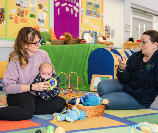 Peer supporter talking to mum and baby